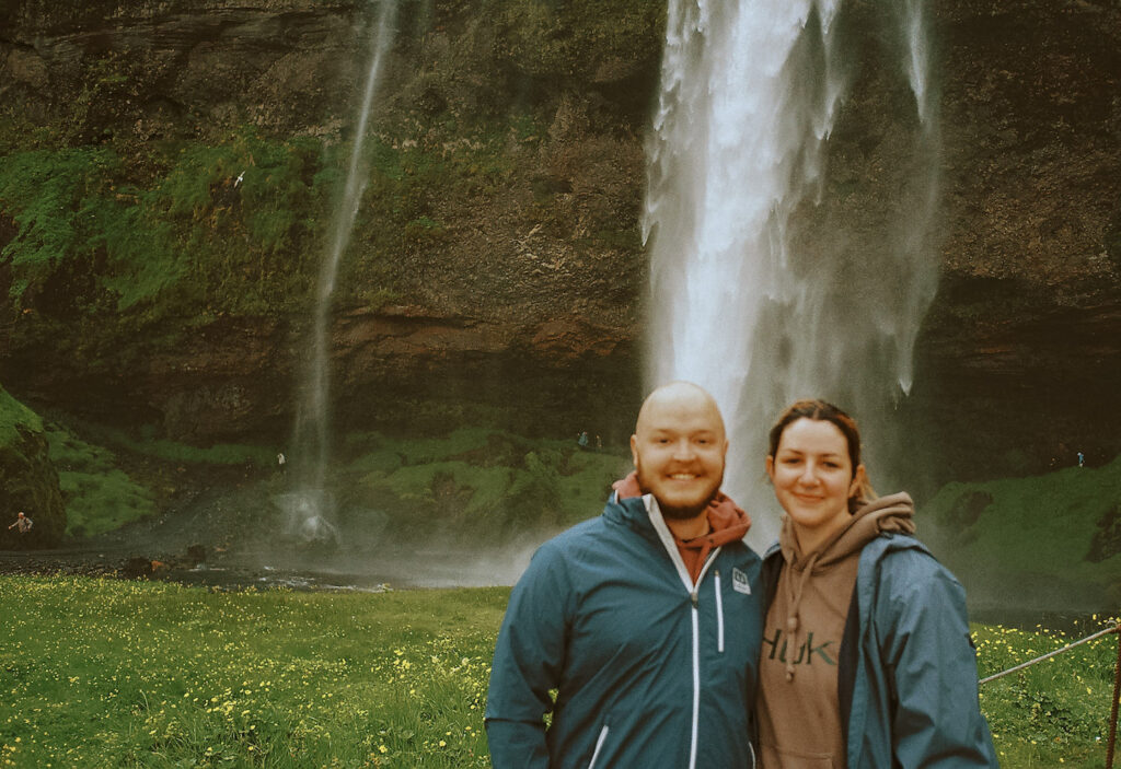 My husband and I standing infront of a waterfall while exploring Iceland during our anniversary celebration. 