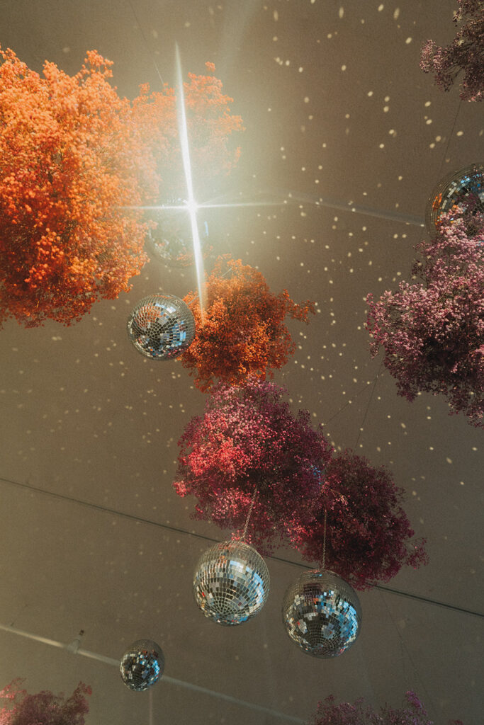 Disco balls and colorful florals are shown at a Long Branch NJ wedding 