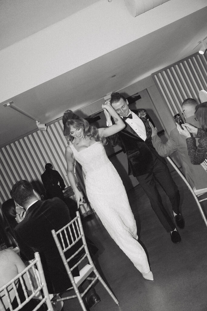 Newlyweds celebrate their Long Branch NJ wedding in this black and white image 