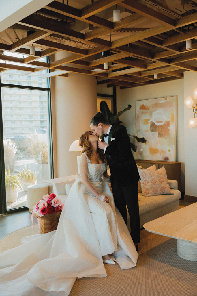 Newlyweds share a kiss at their eclectic November wedding held at The Wave Resort in NJ 