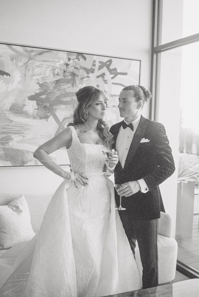 A film scan depicts a black and white image of newlyweds enjoying drinks before their wedding ceremony at The Wave Resort 