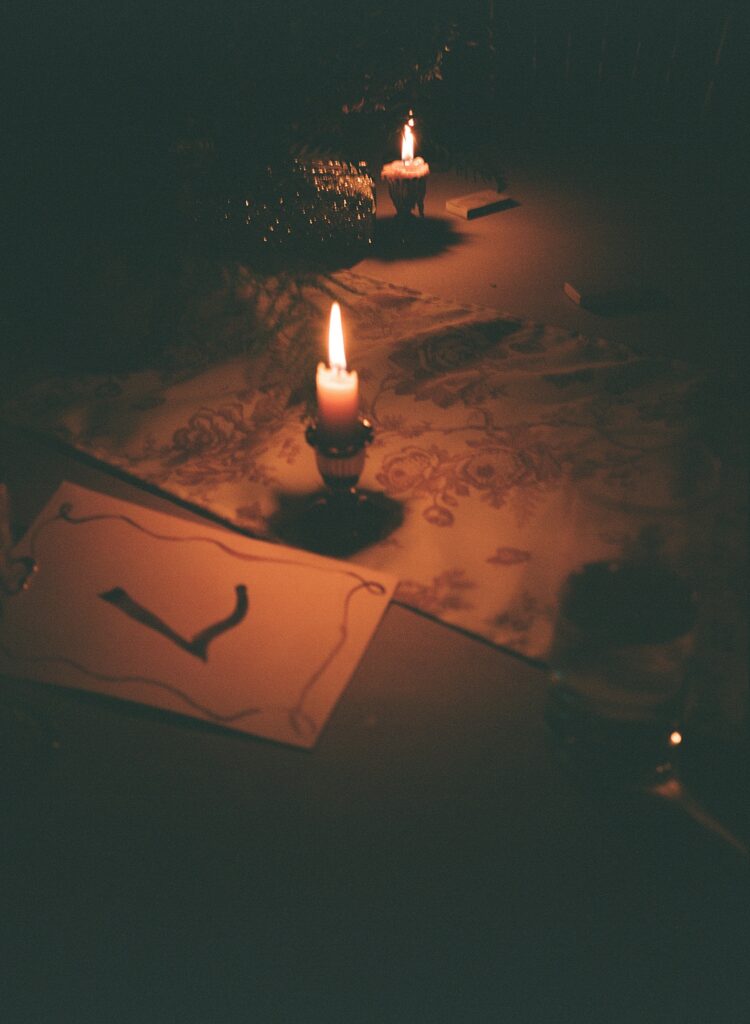 Details of a reception tablscape including lit candles are shown at a ridley creek wedding
