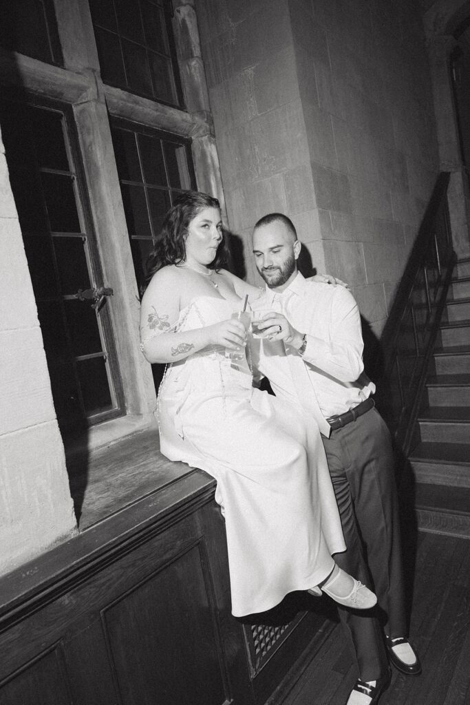 A b+w flash photography image taken at a ridley creek state park wedding show a bride & groom enjoying cocktails at their reception