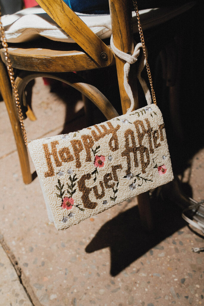 A purse that reads 'Happily Ever After' is photographed at an american swedish museum wedding