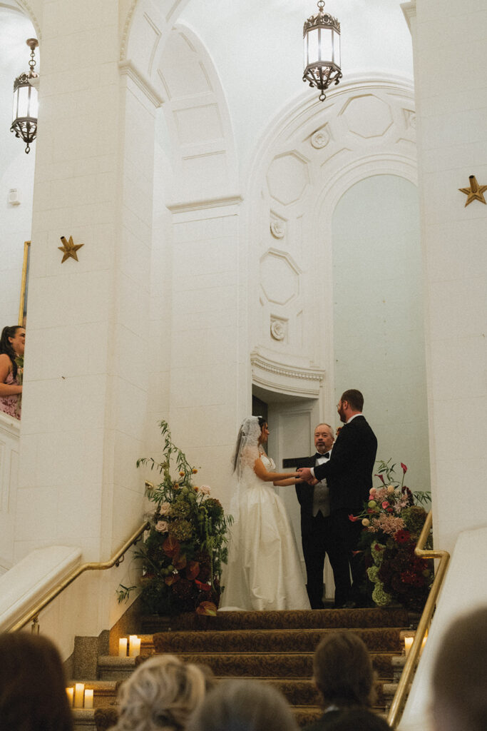 Vows are exchanged in this ceremony photo taken at an american swedish historical museum wedding