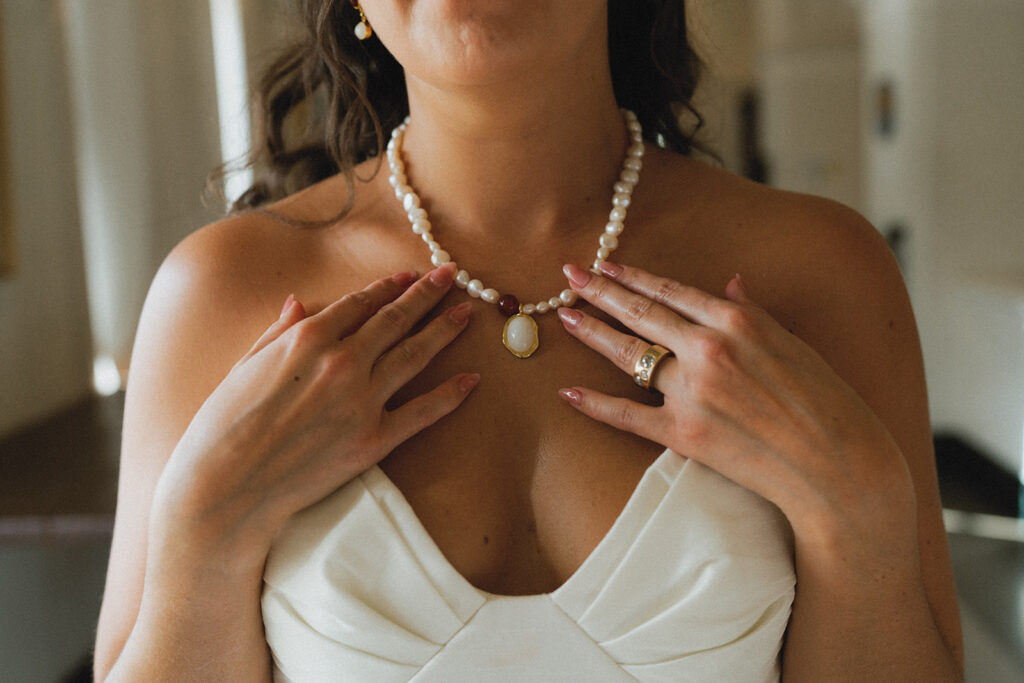 A bridal portrait showcases the bride's pearl necklace at an american swedish historical museum wedding