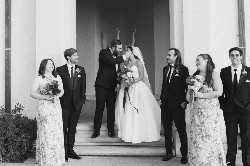 A bride and groom pose with their bridal party before their philly art museum wedding